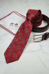 Red silk tie with textured polka dots, perfect for formal wear and weddings.